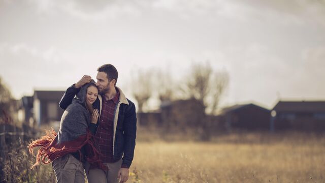 Couple smiling together at home in garden.